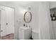 A renovated bathroom features a shower with subway tile, a modern vanity, and a round mirror with modern vanity lights at 1045 28Th S Ave, St Petersburg, FL 33705