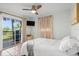 Bedroom features a sliding glass door to a small deck, a ceiling fan, and terracotta floors at 1045 28Th S Ave, St Petersburg, FL 33705