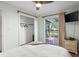 Bedroom with light blue walls features a closet, sliding glass door, deck and terracotta floors at 1045 28Th S Ave, St Petersburg, FL 33705