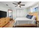 A bright bedroom with light blue walls and tile floors features a ceiling fan, a wooden bed, and a tall dresser at 1045 28Th S Ave, St Petersburg, FL 33705