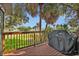 Relaxing outdoor deck features wood decking, railing, palm trees, and a grill perfect for entertaining and enjoying the weather at 1045 28Th S Ave, St Petersburg, FL 33705