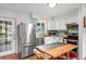 Modern kitchen featuring white cabinets, stainless steel appliances, and a breakfast bar, offering a clean and functional space at 1045 28Th S Ave, St Petersburg, FL 33705