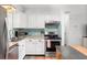 Well-equipped kitchen featuring white cabinetry, stainless steel appliances, and a tiled backsplash for a modern look at 1045 28Th S Ave, St Petersburg, FL 33705