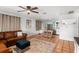 Open-concept living room with a leather sofa, decorative rug, and tile flooring, seamlessly connected to the kitchen area at 1045 28Th S Ave, St Petersburg, FL 33705
