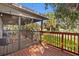 Cozy covered porch with wood floors and ceiling, featuring outdoor seating, a picnic table, and a view of the green yard at 1045 28Th S Ave, St Petersburg, FL 33705