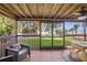 Inviting screened porch with seating, a picnic table, wood floors, and a scenic backyard view at 1045 28Th S Ave, St Petersburg, FL 33705