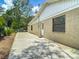 Backyard exterior view featuring a concrete patio, white trim, and an enclosed backyard with privacy at 10930 Marjory Ave, Tampa, FL 33612