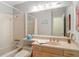 Bathroom with tub and shower, large mirror, and vanity at 10930 Marjory Ave, Tampa, FL 33612