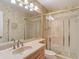 Bathroom with tile shower and glass doors, and a large mirror at 10930 Marjory Ave, Tampa, FL 33612