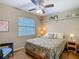 Bedroom with neutral walls, carpet, window with blinds, and ceiling fan at 10930 Marjory Ave, Tampa, FL 33612