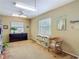 Bright bedroom with carpet floor, two windows, storage shelves, and a peaceful ambiance at 10930 Marjory Ave, Tampa, FL 33612