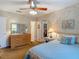 Bedroom with dresser, closet, ceiling fan, and neutral carpet at 10930 Marjory Ave, Tampa, FL 33612