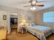 Bedroom with textured wall, ceiling fan, and decor at 10930 Marjory Ave, Tampa, FL 33612