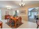 Charming dining room with wood table, two chandeliers, and neutral color palette at 10930 Marjory Ave, Tampa, FL 33612