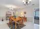 Charming dining room with a wood table and wrought iron chandelier at 10930 Marjory Ave, Tampa, FL 33612