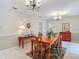 Cozy dining room featuring a wooden table, decorative chandelier and neutral wall colors at 10930 Marjory Ave, Tampa, FL 33612
