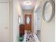 Inviting foyer with tile flooring, front door with oval window, and decorative mirror at 10930 Marjory Ave, Tampa, FL 33612