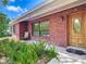 Welcoming front porch with brick facade, inviting entrance, and lush landscaping enhancing curb appeal at 10930 Marjory Ave, Tampa, FL 33612