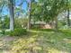 Charming one-story brick home with a well-manicured lawn and mature trees creating a serene setting at 10930 Marjory Ave, Tampa, FL 33612