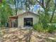 Metal garage with a shed, perfect for extra storage and covered parking on the property at 10930 Marjory Ave, Tampa, FL 33612