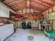 Spacious metal garage interior with shelves for storage and a workbench for DIY projects at 10930 Marjory Ave, Tampa, FL 33612