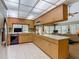 Functional kitchen with wooden cabinets, tile floors, and modern appliances at 10930 Marjory Ave, Tampa, FL 33612