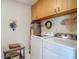 Convenient laundry room with Samsung washer/dryer, water heater, oak cabinets and charming decorations at 10930 Marjory Ave, Tampa, FL 33612