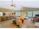 Bright and airy living room featuring a ceiling fan, neutral colors and seamless connection to the kitchen at 10930 Marjory Ave, Tampa, FL 33612