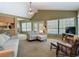 Spacious living room with vaulted ceilings, neutral decor, large windows and access to the outdoor pool area at 10930 Marjory Ave, Tampa, FL 33612
