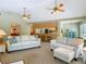 Spacious living area with comfortable seating, open to the kitchen with bar stools, and good lighting at 10930 Marjory Ave, Tampa, FL 33612