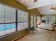 Bright living space overlooking the pool area, featuring large windows and comfortable seating at 10930 Marjory Ave, Tampa, FL 33612