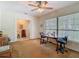 Bright office space with a large window, neutral carpet, and ceiling fan at 10930 Marjory Ave, Tampa, FL 33612