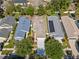 An aerial shot showcases the property's landscaping and curb appeal in a residential setting at 11363 Cocoa Beach Dr, Riverview, FL 33569