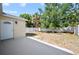 A backyard with a covered patio and privacy fence, offers a secure outdoor space at 11363 Cocoa Beach Dr, Riverview, FL 33569