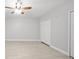 A spacious bedroom featuring neutral walls, ceiling fan, and closet with tile flooring at 11363 Cocoa Beach Dr, Riverview, FL 33569