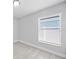 Bright bedroom showcasing a window, neutral walls, and tile flooring at 11363 Cocoa Beach Dr, Riverview, FL 33569