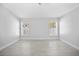 A bright empty bedroom space with two windows and tile flooring at 11363 Cocoa Beach Dr, Riverview, FL 33569