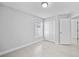 Bright bedroom showcasing a window, neutral walls, and tile flooring at 11363 Cocoa Beach Dr, Riverview, FL 33569