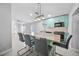 Open-concept kitchen with an island, modern light fixtures and an adjoining living area at 11363 Cocoa Beach Dr, Riverview, FL 33569