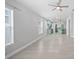 Bright, open-concept living space with modern flooring and a view of the kitchen at 11363 Cocoa Beach Dr, Riverview, FL 33569