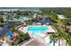 An aerial view of multiple community pools, with sunshades and play area at 11363 Cocoa Beach Dr, Riverview, FL 33569