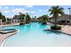 Resort-style community pool with sunning islands, fountains, and lush landscaping at 11363 Cocoa Beach Dr, Riverview, FL 33569