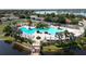 Community pool featuring palm trees, deck chairs, and lake views at 11363 Cocoa Beach Dr, Riverview, FL 33569