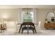 Stylish dining area with a modern table, comfortable seating, and abundant natural light at 114 Leisure Pl, Rotonda West, FL 33947