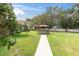 Well-maintained backyard with a charming gazebo set amidst lush greenery, creating a tranquil outdoor space at 11615 Mango Ridge Blvd # 39, Seffner, FL 33584