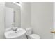 Bathroom featuring a white sink, toilet, and a well-lit mirror at 11615 Mango Ridge Blvd # 39, Seffner, FL 33584