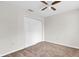 Neutral bedroom with carpet, ceiling fan and closet perfect for relaxation and storage at 11615 Mango Ridge Blvd # 39, Seffner, FL 33584