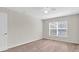Bedroom with neutral walls, carpet flooring, and a large window for natural light at 11615 Mango Ridge Blvd # 39, Seffner, FL 33584