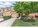 Inviting townhome showcases a well-maintained lawn, lovely tree, and an arched entryway at 11615 Mango Ridge Blvd # 39, Seffner, FL 33584