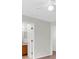 Hallway featuring a ceiling fan, neutral walls, and two white doors at 11615 Mango Ridge Blvd # 39, Seffner, FL 33584